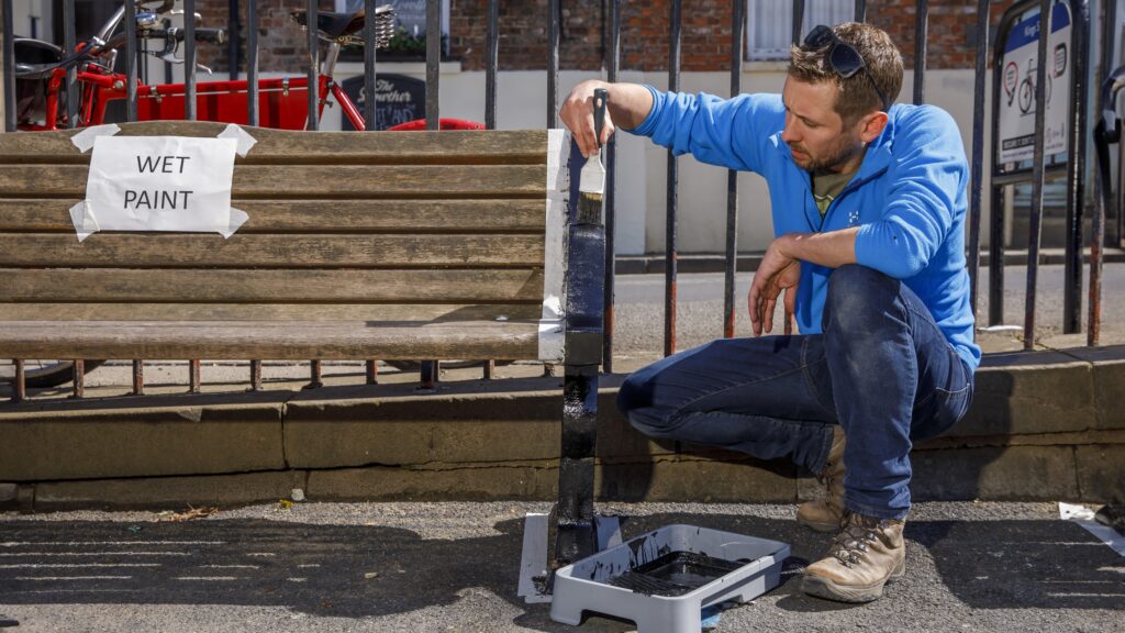 Volunteer painting a bench on King's Staith